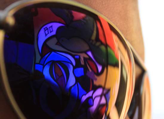 Colourful graffiti reflected in a lens.