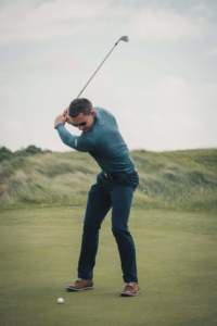 Golfer taking a swing at the ball