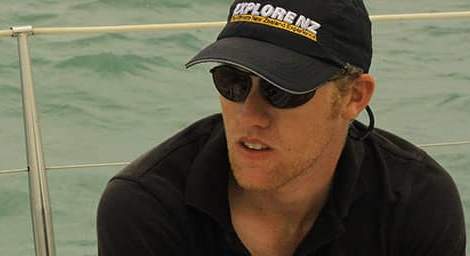 Man sitting on a boat wearing Bigatmo sunglasses-Polarized-lens and a baseball cap