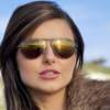 Dark haired girl with white cliffs of Dover in the background, wearing Bigatmo Tropo sunglasses.