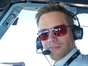 Commercial pilot wearing Bigatmo Iono photochromic sunglasses with ANR headset.