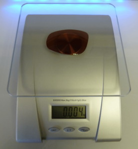 Alutra lens on the scales